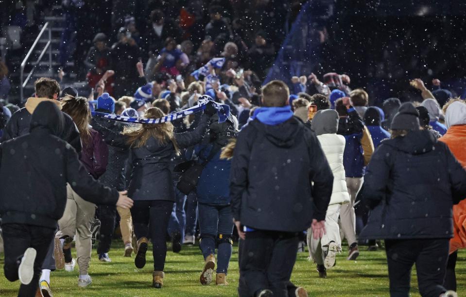 Fans storm the field after BYU beat North Carolina during the NCAA tournament quarterfinals in Provo on Friday, Nov. 24, 2023. BYU won, 4-3, and will face Stanford in the College Cup semifinals Friday night in North Carolina. | Jeffrey D. Allred, Deseret News