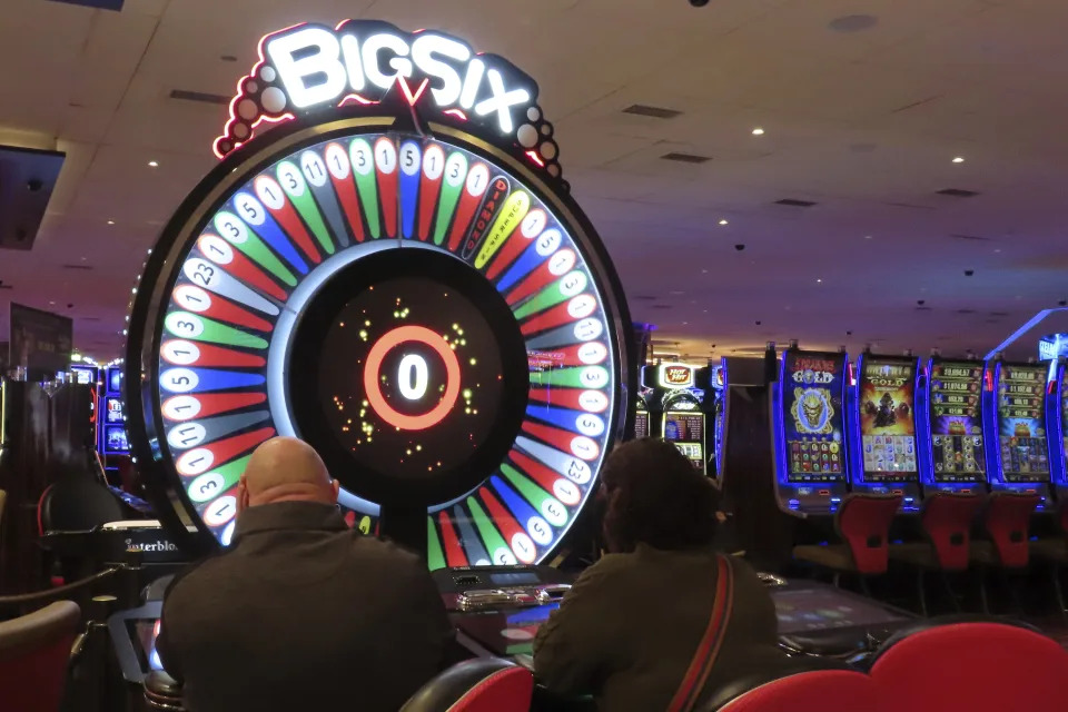 Gamblers play a cash wheel at the Hard Rock casino in Atlantic City, N.J. on Feb. 2, 2024. Figures released on Friday, Feb. 16, from state gambling regulators show the total amount won by Atlantic City's nine casinos, the three horse tracks that take sports bets, and their online partners was more than $559 million in January, up 28% from a year earlier. But much of that was powered by a record-setting month of internet gambling ($183 million, up nearly 20% from a year ago) and sports betting (nearly $171 million, up more than 136%). (AP Photo/Wayne Parry)