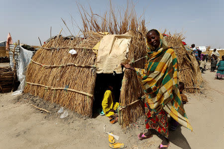 A woman poses by her straw grass home at the IDP camp at Gamboru, Borno, Nigeria April 27, 2017. REUTERS/Afolabi Sotunde