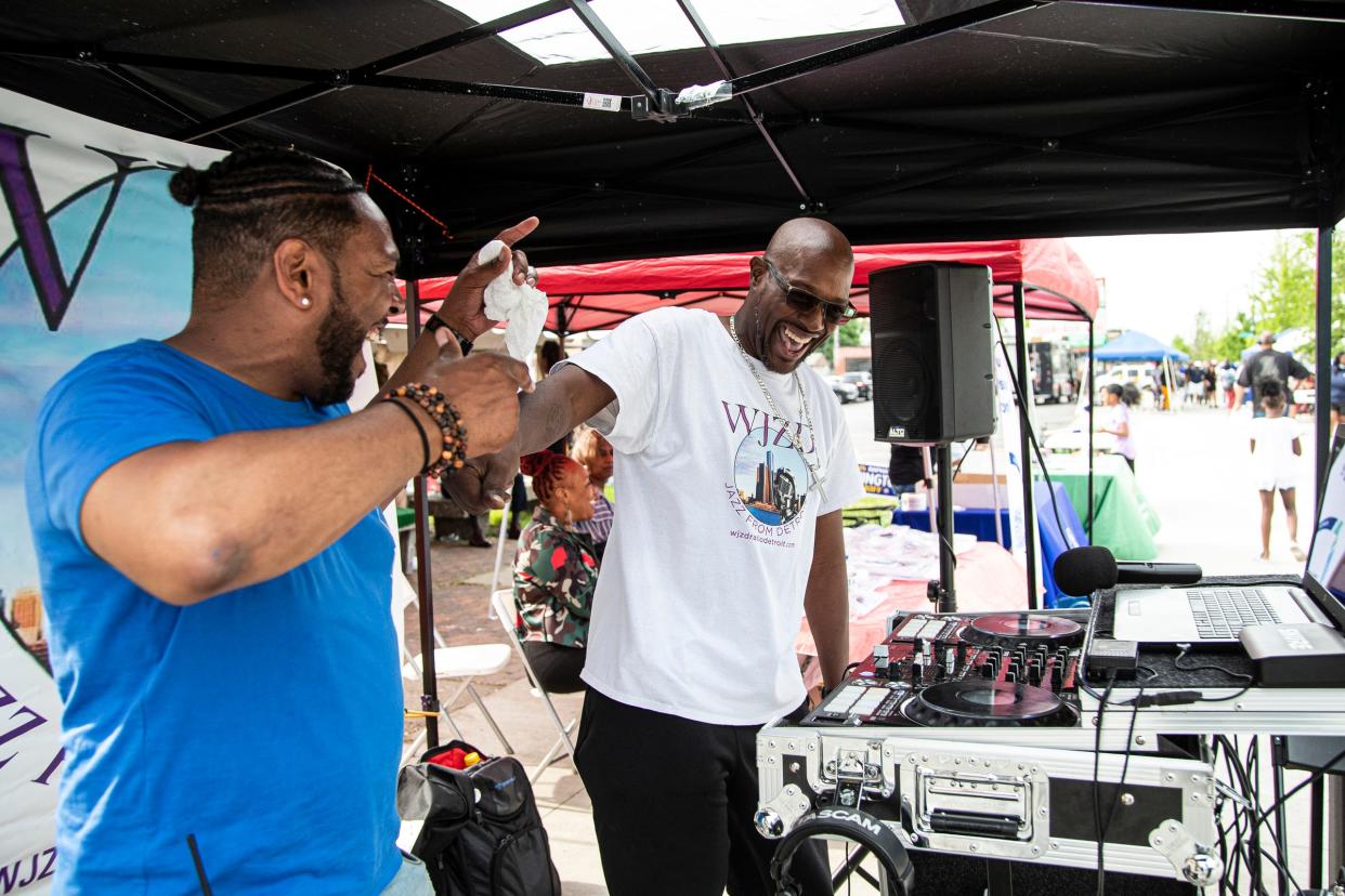 Vaughn Arrington, left, dances with DJ Outcold on Livernois Avenue during the Taste of Livernois as a part of Detroit Public Schools Community District's Alumni Weekend in Detroit on Saturday, May 21, 2022.