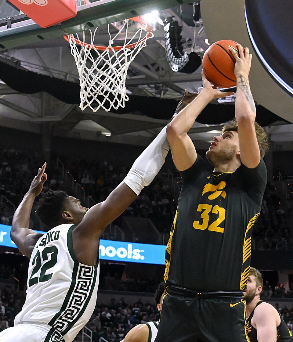 Iowa Hawkeyes forward Owen Freeman (32) shoots past Michigan State Spartans center Mady Sissoko (22) during the first half at Breslin Center in East Lansing on Tuesday, Feb. 20, 2024.