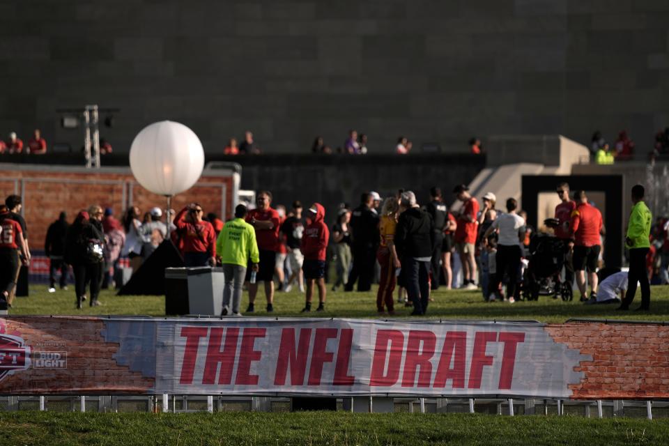 People leave after the third day of the NFL football draft, Saturday, April 29, 2023, in Kansas City, Mo.