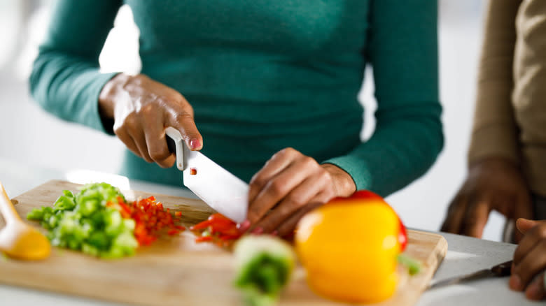 Person chopping bell peppers