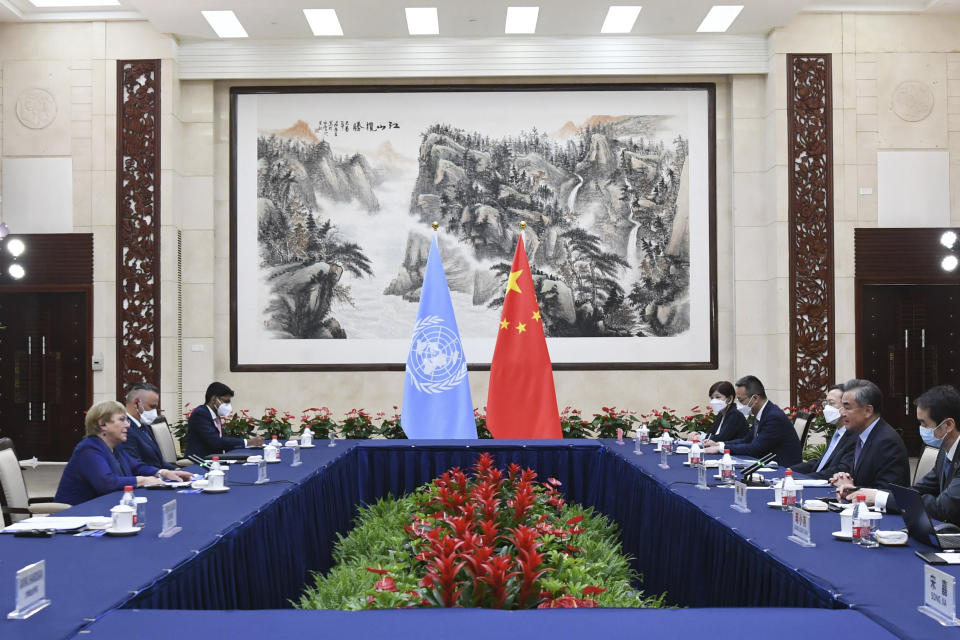 In this photo released by Xinhua News Agency, Chinese Foreign Minister Wang Yi, second right, meets with the United Nations High Commissioner for Human Rights Michelle Bachelet, left, in Guangzhou, southern China's Guangdong Province on Monday, May 23, 2022. China opposes “politicizing” human rights and imposing double standards, its foreign minister said in comments at the start of a visit by a top United Nations official focused on allegations of abuses against Muslim minorities in the northwestern region of Xinjiang. (Deng Hua/Xinhua via AP)