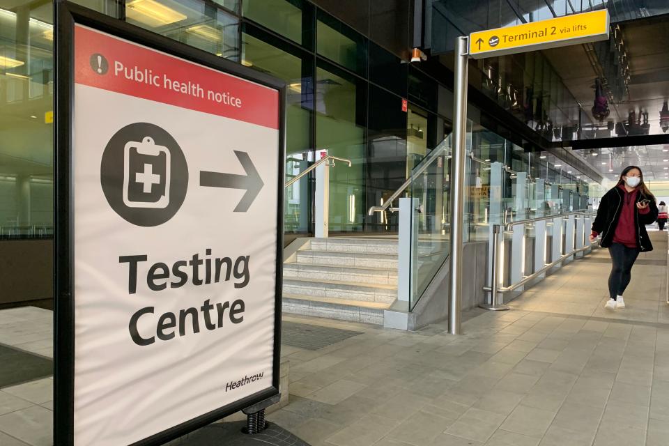 A sign points the way for a Covid-19 testing centre at Terminal 2 in at London Heathrow Airport in west London, on January 18, 2021. - All arrivals to the UK will have to quarantine and show negative tests for Covid-19 from today at 0400 GMT, after the government scrapped 