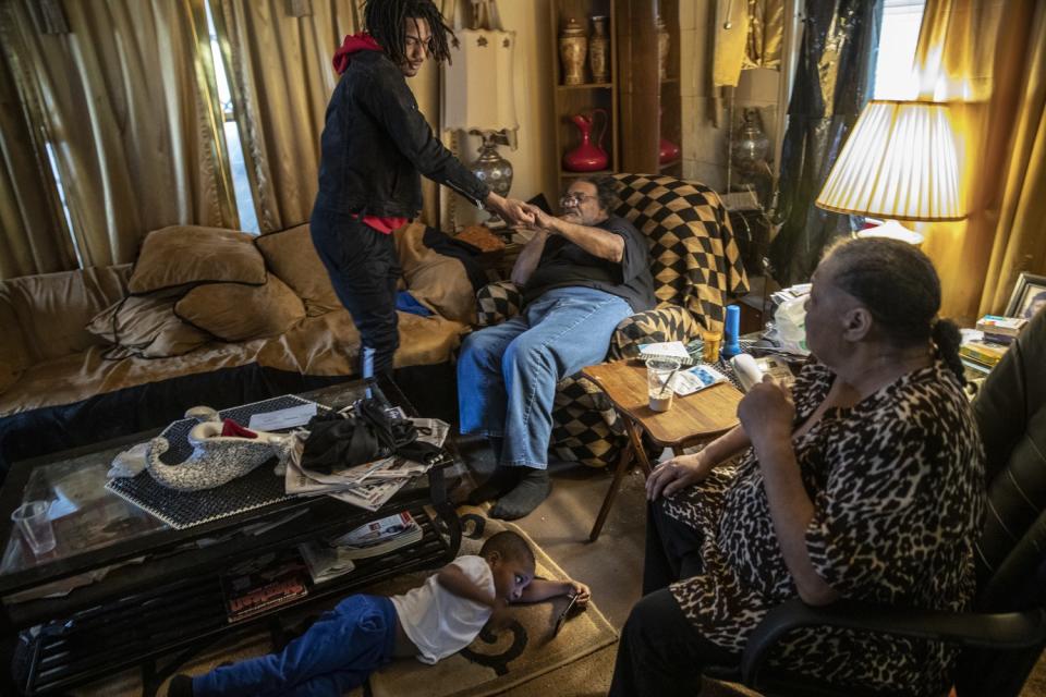 Taevion Rushing with his grandfather, Dennis Rushing, and grandmother, Linda, at home.