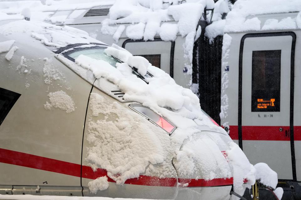 Snow covered trains are parked at the central station after heavy snow fall in Munich, Germany, Saturday, Dec. 2, 2023. (AP Photo/Matthias Schrader)