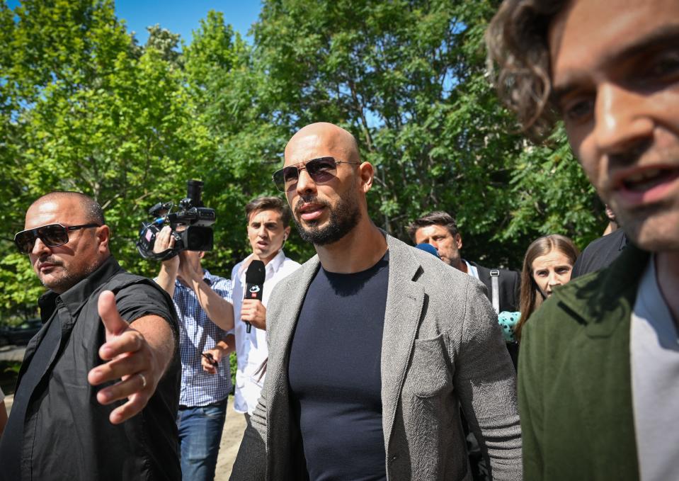 Controversial influencer Andrew Tate (C) arrives at the Municipal Court of Bucharest, Romania, on June 21, 2023. Influencer Andrew Tate, a self-described misogynist with a large online presence, was indicted in Romania on human trafficking and rape charges, officials said on June 20, 2023.
Tate's brother Tristan and two Romanian women were also charged in the case, which has drawn intense international attention. (Photo by Daniel MIHAILESCU / AFP) (Photo by DANIEL MIHAILESCU/AFP via Getty Images)