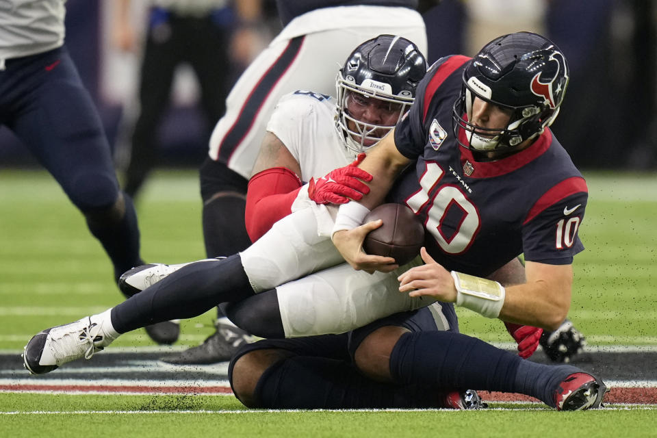 Tennessee Titans defensive tackle Jeffery Simmons sacks Houston Texans quarterback Davis Mills (10) for a 12-yard loss during the second half of an NFL football game Sunday, Oct. 30, 2022, in Houston. (AP Photo/Eric Christian Smith)