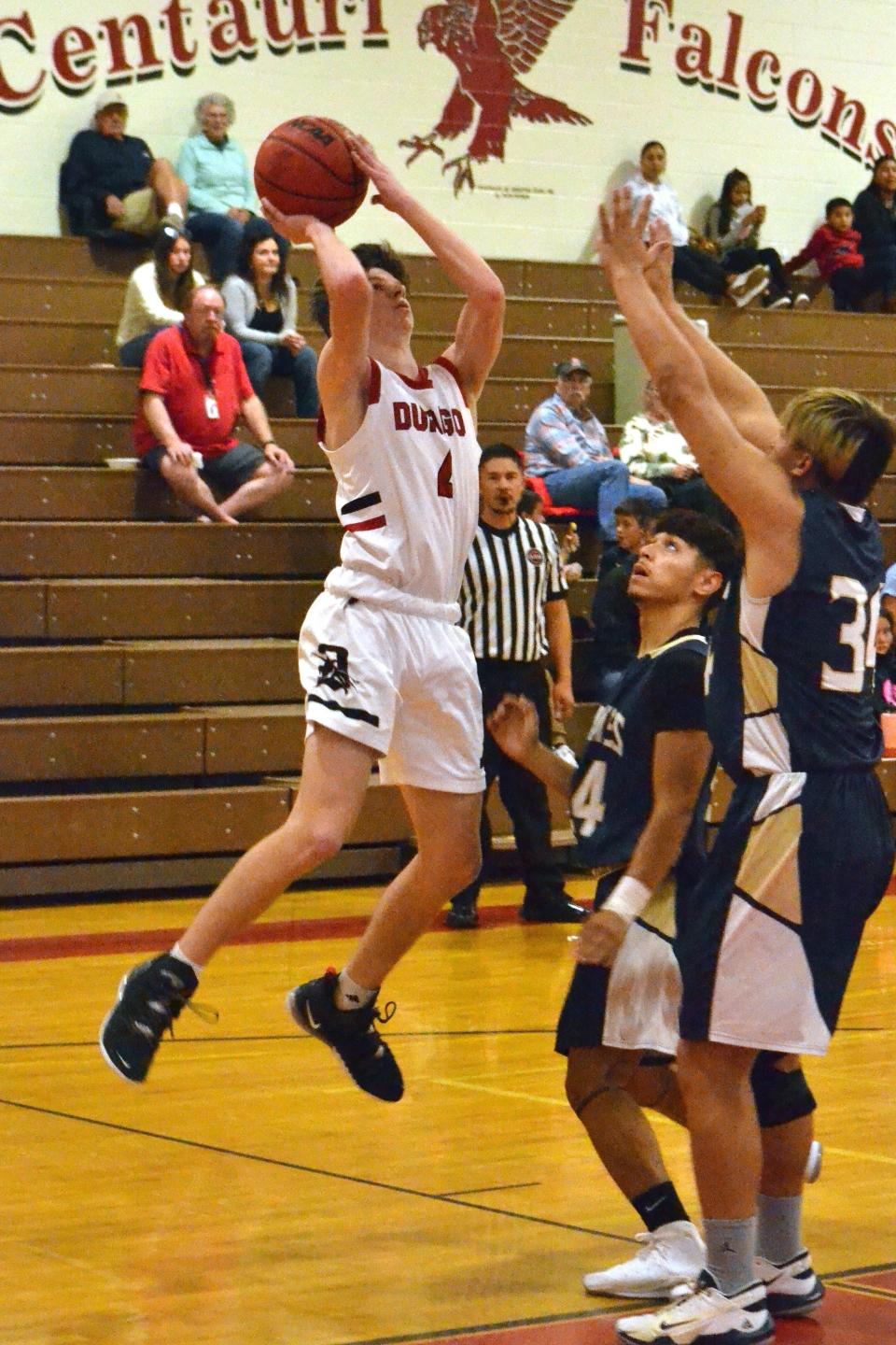 Durango's Dylan Bettin (4) tries a jump shot in front of a pair of Olathe defenders during a tournament game on Saturday, Dec. 4, 2021. The Demons are one of eight teams competing this week in the Marv Sanders Memorial Invitational, which begins Thursday at Scorpion Arena.