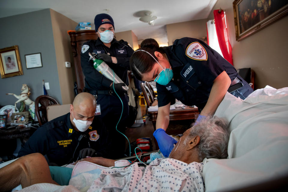 Image: Medics prepare to intubate a patient showing COVID-19 symptoms at his home in Yonkers, N.Y., on April 6, 2020. (John Moore / Getty Images file)