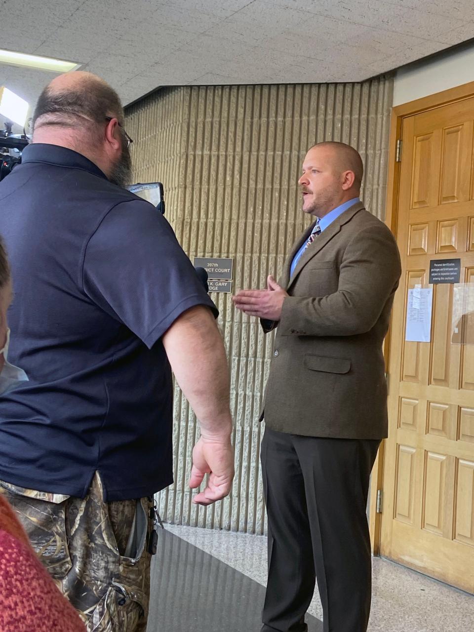 John Palmer speaks to reporters outside a district courtroom Friday after a judge dismissed his petition to remove Grayson County Judge Bill Magers from office.