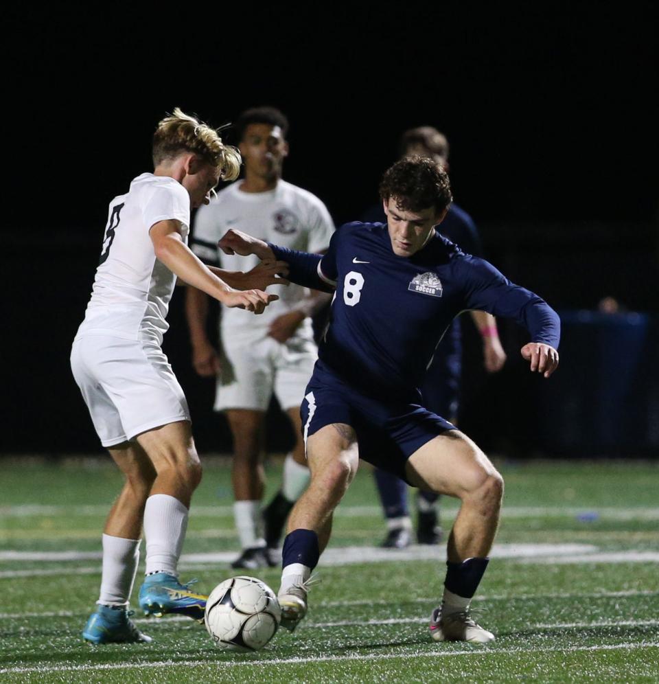 Beacon's Brody Timm clears the ball away from O'Neill's Jacques Farlow during Thursday's game on October 12, 2023.