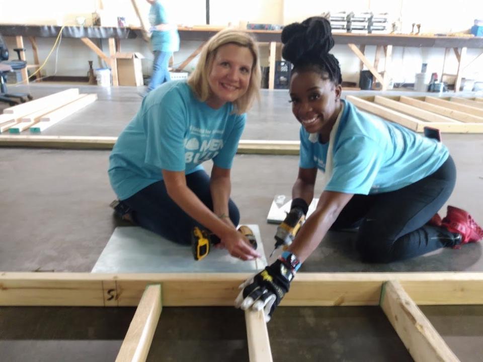 First Lady Elee Reeves and Delta Sigma Theta Sorority volunteer Teneshia Smith work to attach two by four beams to a frame that will eventually be part of the new Habitat Women Build home in Jackson’s Broadmoor area.