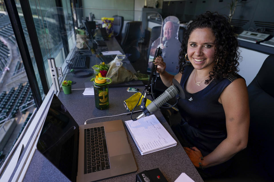 Amelia Schimmel, the new public address announcer for the Oakland Athletics, sits in the press box before a baseball game against the Houston Astros, Thursday, April 1, 2021, on opening day in Oakland, Calif. Schimmel succeeds the late Dick Callahan, who passed away in January after serving as the team's PA announcer for 15 seasons. (AP Photo/Tony Avelar)