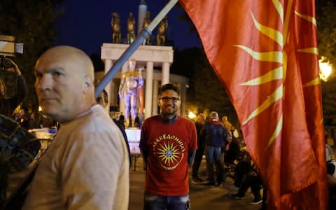 Supporters of a boycott of the referendum outside parliament in Skopje, Macedonia's capital, after turnout was reported to be just 29% - Credit: Thanassis Stavrakis/AP