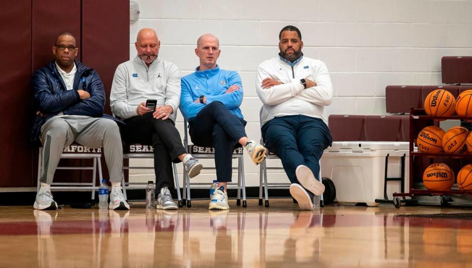 University of North Carolina coaches Hubert Davis, Jeff Lebo, Brad Frederick and Sean May watch Jarin Stevenson (15) play during a victory over Jordan-Matthews on January 31, 2023 in Pittsboro, N.C.