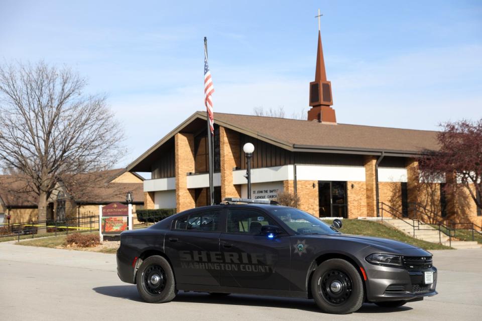 The Washington County Sheriff's office investigates the scene of a fatal stabbing on a Catholic priest in the rectory of St. John the Baptist Church (Omaha World-Herald)