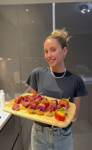 <p>Alix Earle/Tiktok</p> Alix Earle shows off her cooking during date night with Braxton Berrios