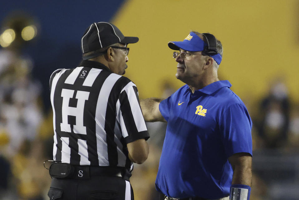 Pittsburgh head coach Pat Narduzzi speaks with an official during the second half of an NCAA college football game against West Virginia, Saturday, Sept. 16, 2023, in Morgantown, W.Va. (AP Photo/Chris Jackson)