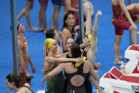 The team from Australia celebrates after winning the final of the women's 4x100m freestyle relay at the 2020 Summer Olympics, Sunday, July 25, 2021, in Tokyo, Japan. (AP Photo/Petr David Josek)