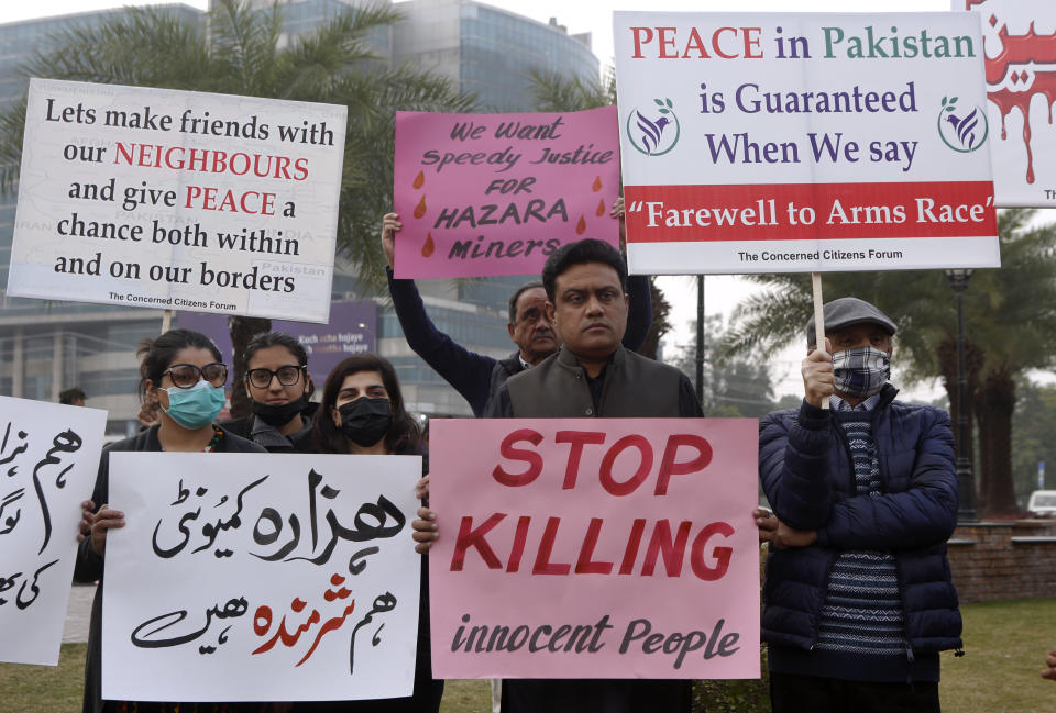 Supporters of a civil society organization hold a demonstration to protest against the killing of coal mine workers by gunmen near the Machh coal field, in Lahore, Pakistan, Friday, Jan. 8, 2021. Pakistan's prime minister Friday appealed the protesting minority Shiites not to link the burial of 11 coal miners from Hazara community who were killed by the Islamic State group to his visit to the mourners, saying such a demand amounted to blackmailing the country's premier. (AP Photo/K.M. Chaudary)