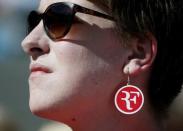 A fan wears a Roger Federer earing at the Wimbledon Tennis Championships in London, June 30, 2015. REUTERS/Stefan Wermuth