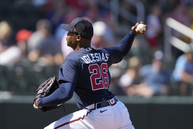 Atlanta Braves relief pitcher Raisel Iglesias (26) throws in the fourth inning of a spring training baseball game against the Minnesota Twins in North Port, Fla., Saturday, March 4, 2023. (AP Photo/Gerald Herbert)