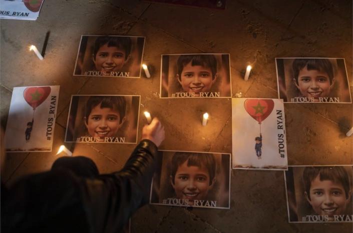 Posters illustrating the boy lye next to candles.