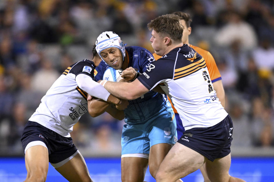 Christian Lealiifano of Moana Pasifika is tackled by Billy Pollard of the Brumbies during the Super Rugby Pacific Round 5 match between the ACT Brumbies and Moana Pasifika in Canberra, Friday, March 22, 2024. (Lukas Coch/AAP Image via AP)