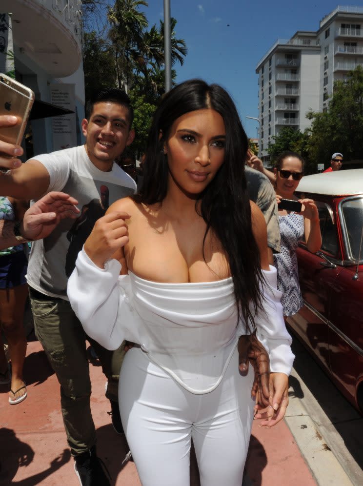 Kim Kardashian showed off in a busty shoulderless top on a shopping trip in Miami Beach. (Photo: Splash)