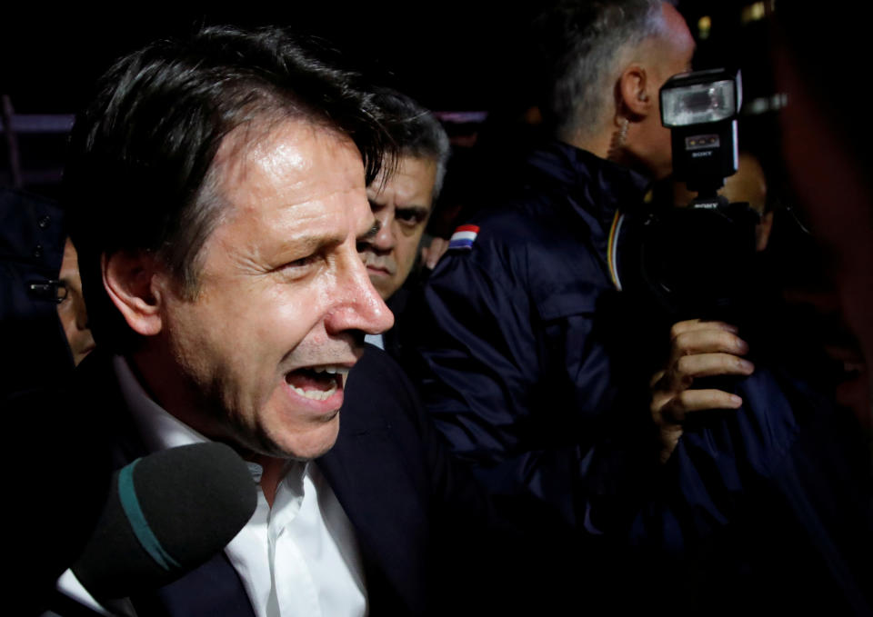 Italian Prime Minister Giuseppe Conte speaks to protesters as he visits the Ilva steel plant, which ArcelorMittal is threatening to abandon over a legal row with the government, in Taranto, Italy, November 8, 2019. REUTERS/Ciro De Luca