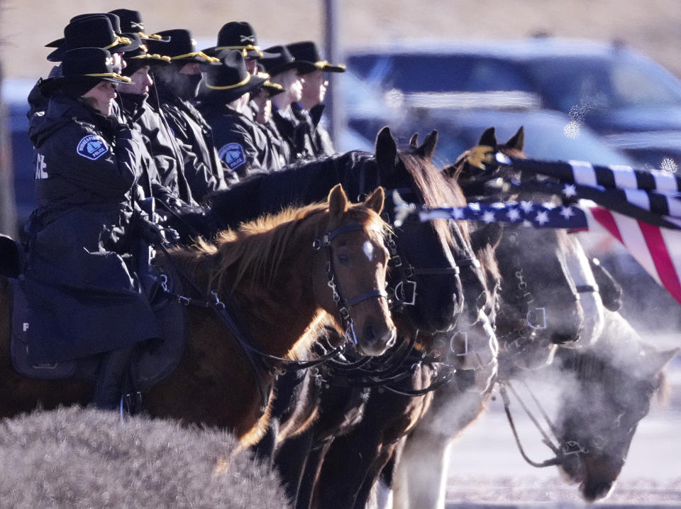 Members of the Minneapolis police mounted patrol arrive ahead of a memorial service for Burnsville police officers Paul Elmstrand, 27, Matthew Ruge, 27, and firefighter-paramedic Adam Finseth, 40, Wednesday, Feb. 28, 2024 at Grace Church in Eden Prairie, Minn. (Anthony Souffle/Star Tribune via AP)