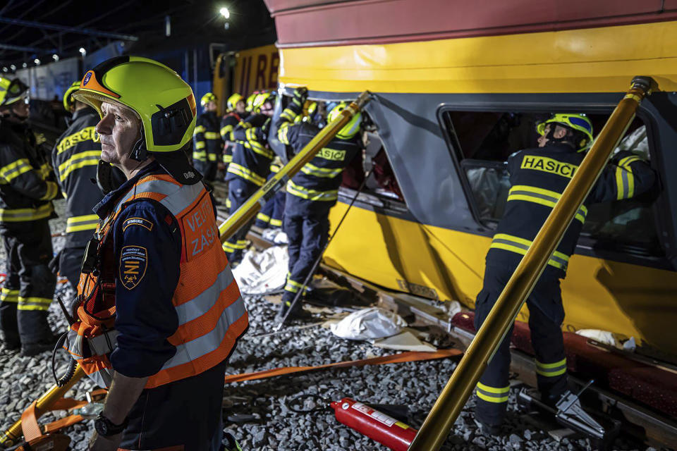 In this photo released by Fire Department of Pardubice region, rescue workers help injured passengers after two trains collided in Pardubice, Czech Republic Thursday, June 6, 2024. A passenger train collided head-on with a freight train in the Czech Republic, killing and injuring some people, officials said early Thursday. (Fire Department of Pardubice region via AP)