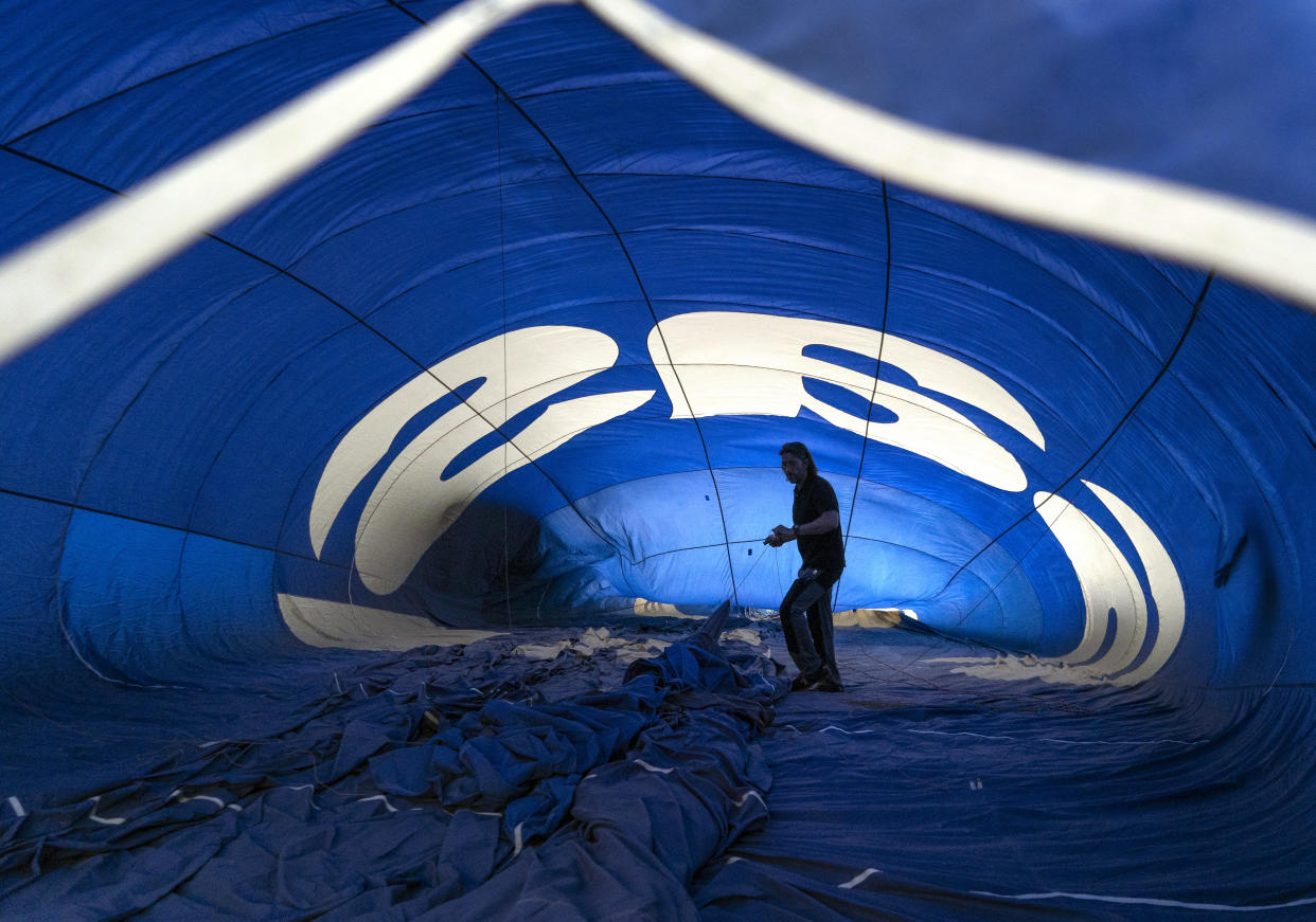 A participant prepares a hot-air balloon for a flight.