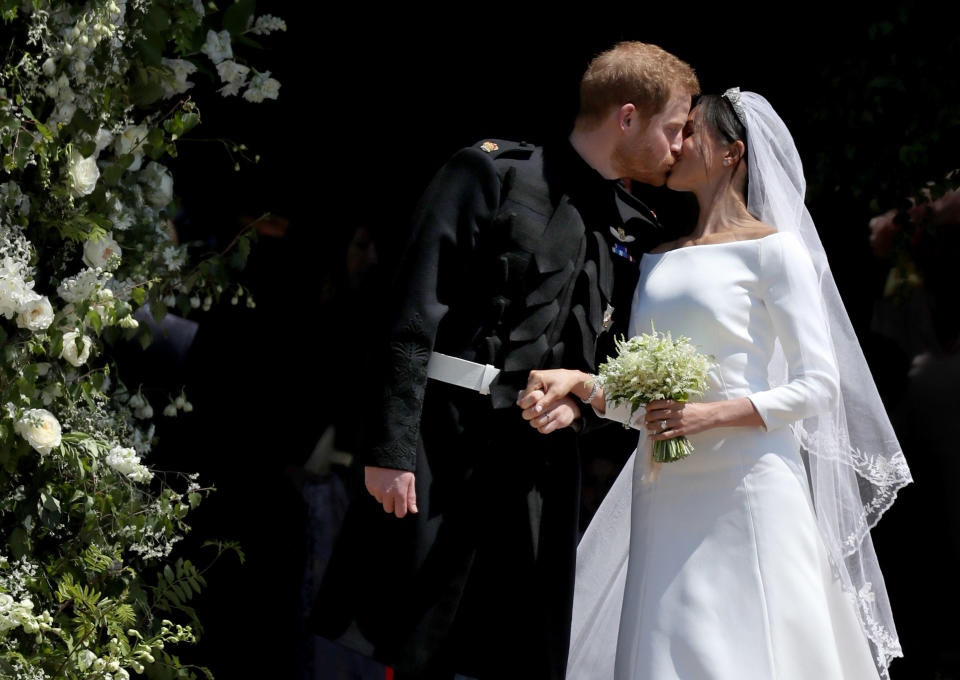 Prince Harry, Duke of Sussex and Meghan, Duchess of Sussex share a kiss after their wedding at St. George's Chapel at Windsor Castle on May 19, 2018 in Windsor, England. / Credit: WPA Pool / Getty Images