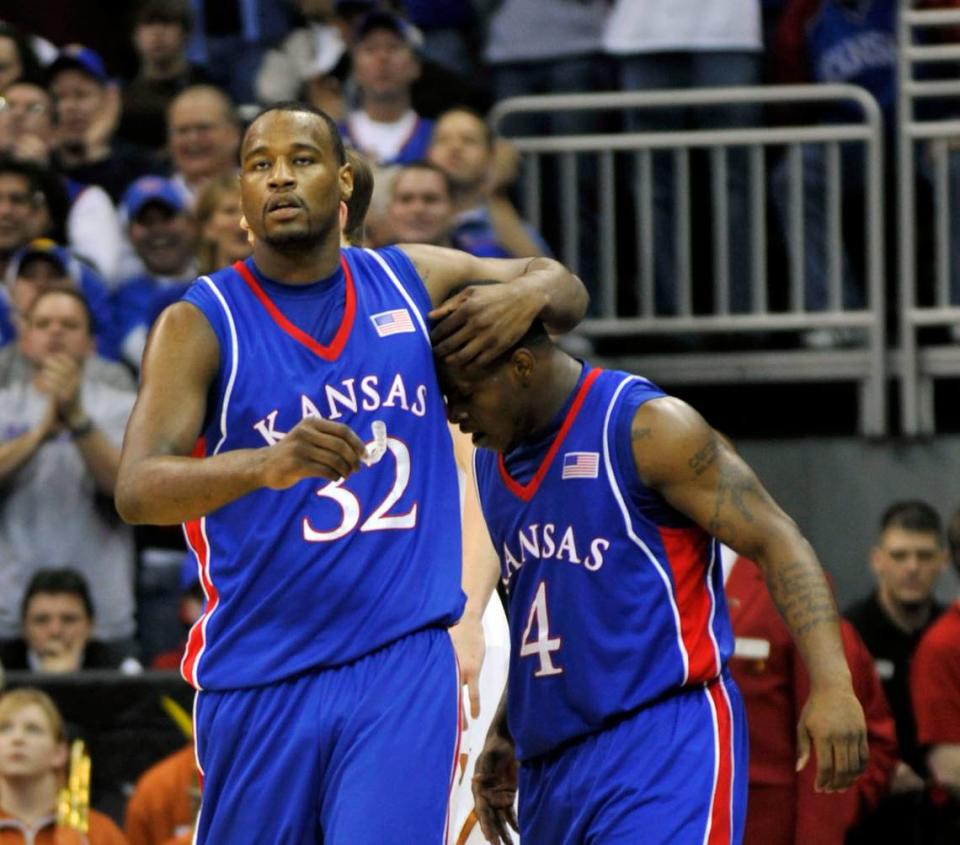 Kansas Jayhawks forward Darnell Jackson (32) warps his arm around guard Sherron Collins (4) late in the second half against the Texas Longhorns during the 2008 Big 12 Tournament championship game at Sprint Center (now T-Mobile Center).
