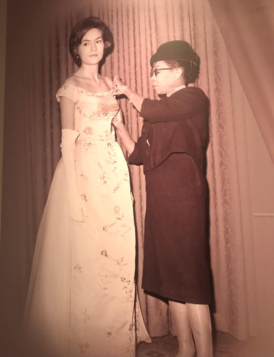 In this photo included in Winterthur's "Ann Lowe: American Couturier" exhibition, the designer is shown fitting a gown on a client. 8/30/2023