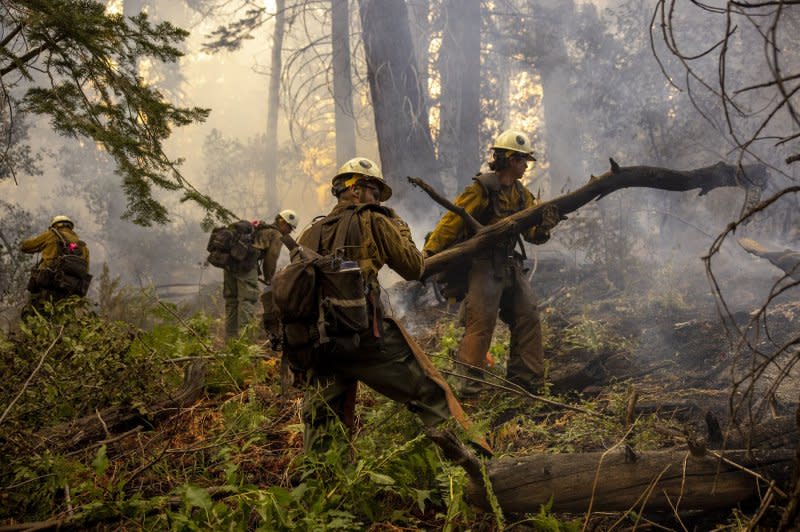 Members of a hot shot crew remove fuel along a containment line during the Caldor fire near Meyers, Calif., in 2021. The Bipartisan Infrastructure Law authorizes $3.37 billion for wildfire risk reduction. File Photo by Peter DaSilva/UPI