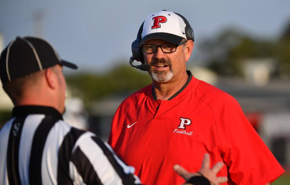 Palmetto High Coach Dave Marino talks to a referee about a foul he thinks they might have missed.