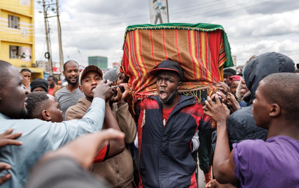 Family, friends and fellow protesters carry the body of Ibrahim Kamau, 19, who was killed during protests at the Kenyan parliament