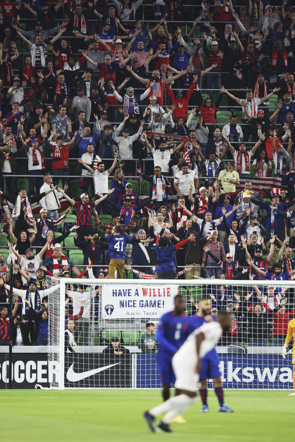 Fans celebrate at the start of the first leg of a CONCACAF Nations League soccer quarterfinal between the United States and Trinidad and Tobago on Thursday, Nov. 16, 2023, in Austin, Texas. (AP Photo/Stephen Spillman)