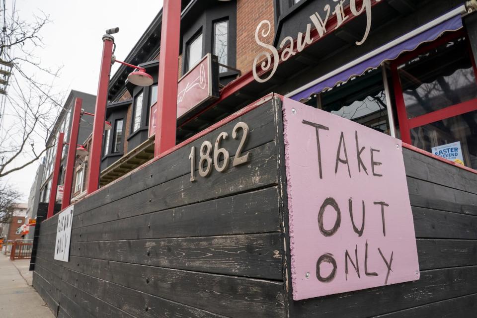 A restaurant in Toronto displays a 'Take Out Only' sign in March 2020, as COVID-19 restrictions clamped down on many businesses who would turn to CEBA loans to survive. (Frank Gunn/The Canadian Press - image credit)
