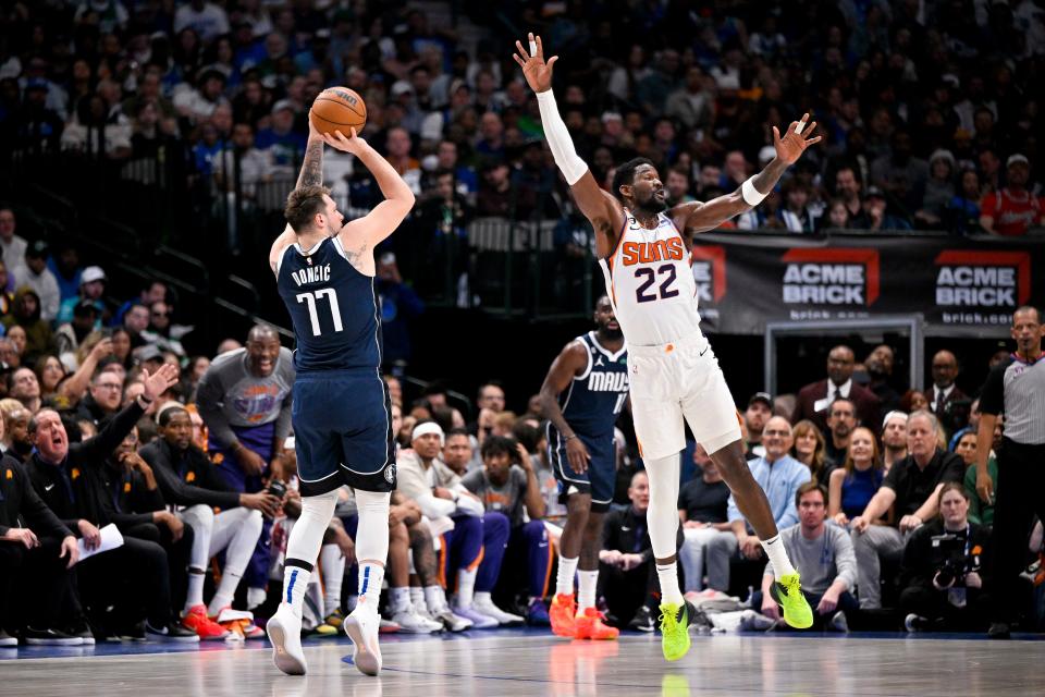 Dallas Mavericks guard Luka Doncic (77) makes a jump shot over Phoenix Suns center Deandre Ayton (22) during the second quarter at the American Airlines Center in Dallas on March 5, 2023.