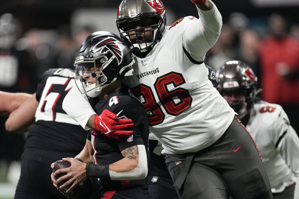 Tampa Bay Buccaneers defensive end Akiem Hicks (96) sacks Atlanta Falcons quarterback Desmond Ridder (4) during the first half of an NFL football game, Sunday, Jan. 8, 2023, in Atlanta. (AP Photo/John Bazemore)