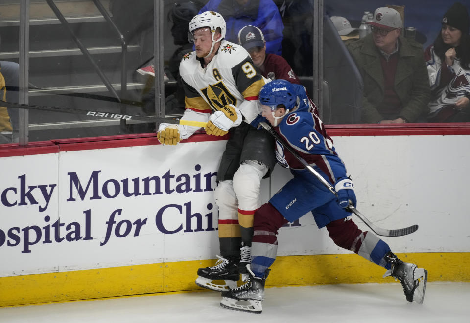 Colorado Avalanche center Ross Colton, front, checks Vegas Golden Knights center Jack Eichel during the third period of an NHL hockey game Wednesday, Jan. 10, 2024, in Denver. (AP Photo/David Zalubowski)