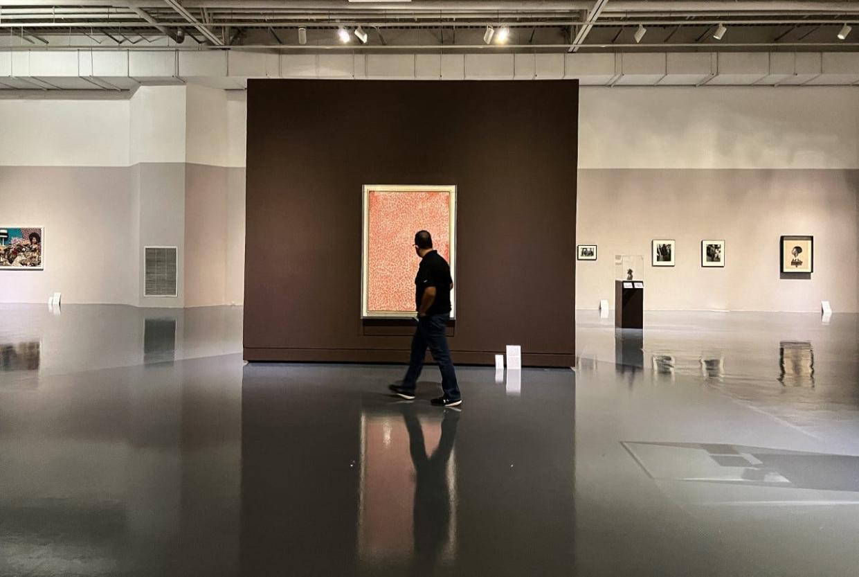 A man on Wednesday walks by the painting "Double Cherry Blossoms," by Alma Thomas, which is in a new art exhibit, “There is a Woman in Every Color: Black Women in Art," opening Friday at the El Paso Museum of Art. It will run through May 14 in the Woody and Gayle Hunt Family Gallery.