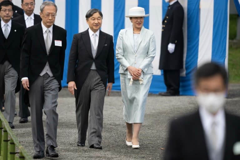 Japan's Emperor Naruhito (2nd R) and Empress Masako (R) walk to greet guests during the spring garden party at the Akasaka Palace imperial garden in Tokyo (Yuichi YAMAZAKI)
