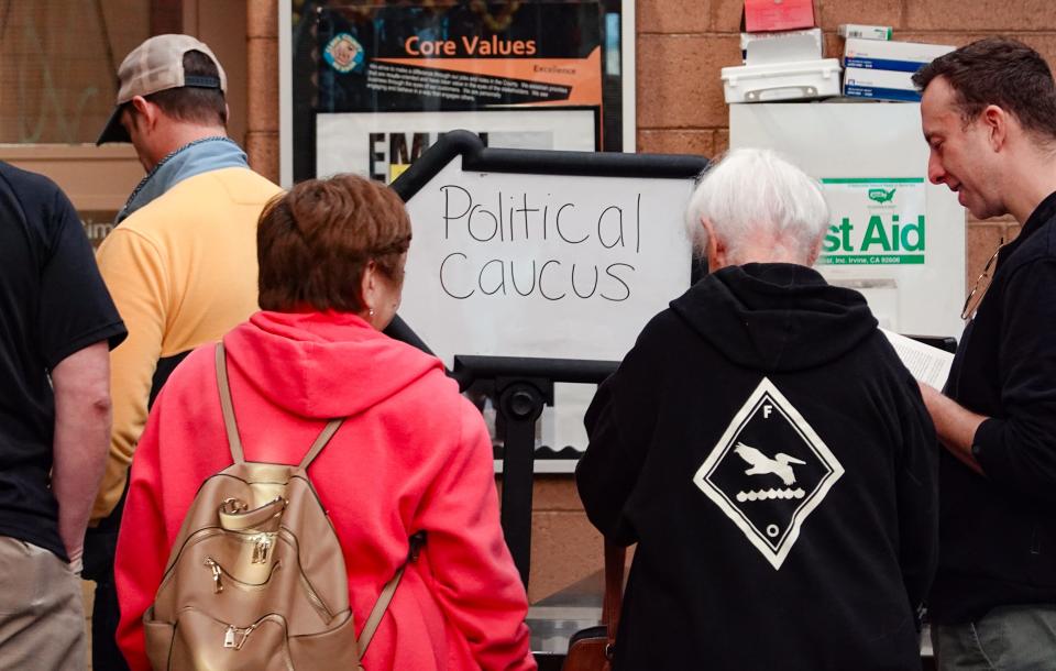 Republican voters stand in line to enter a GOP-run caucus site in Las Vegas on Thursday, Feb. 8, 2024.