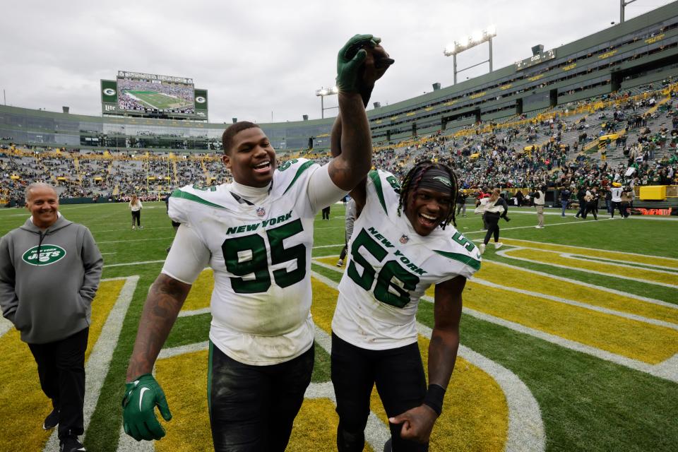 New York Jets defensive tackle Quinnen Williams (95) and linebacker Quincy Williams (56) walk off the field after an NFL football game against the Green Bay Packers, Sunday, Oct. 16, 2022, in Green Bay, Wis. (AP Photo/Mike Roemer)